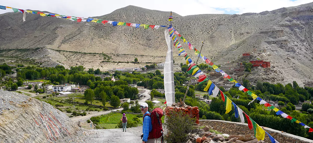 Fresh greenery view of Ghiling Village of Upper Mustang, surrounded by red & grey cliffs.