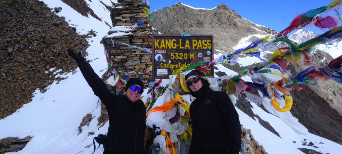Trekkers taking a picture at the top of Kang La Pass at 5320 m